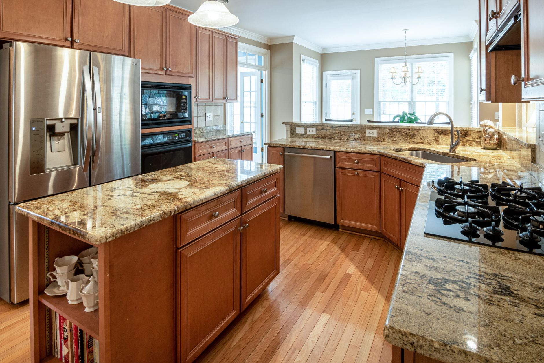 A luxurious kitchen interior featuring granite countertops and modern appliances in Round Rock, TX
